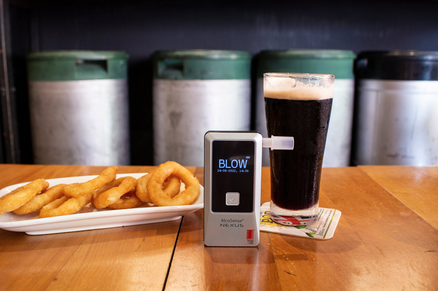 AlcoSense Nexus personal breathalyser at a bar restaurant