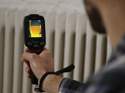 A man using the ThermalSense Thermal Camera EG2+