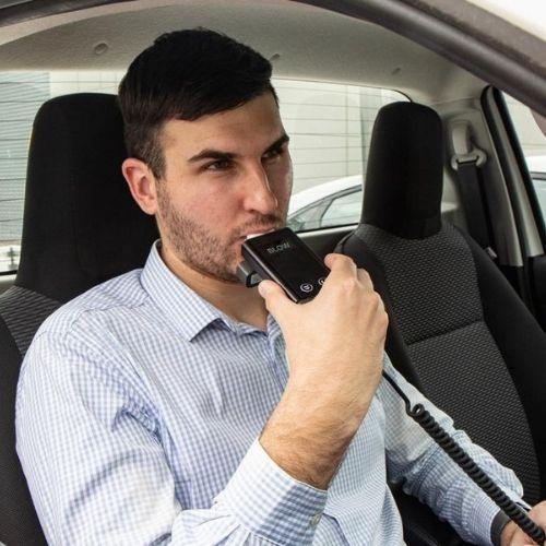 Blowing into a Andatech ALX3000 ignition interlock breathalyser in the car