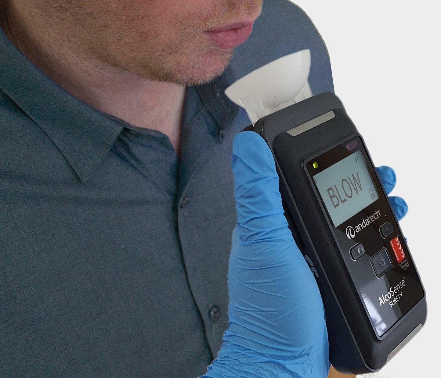 Employee taking passive alcohol test with Andatech Surety breathalyser